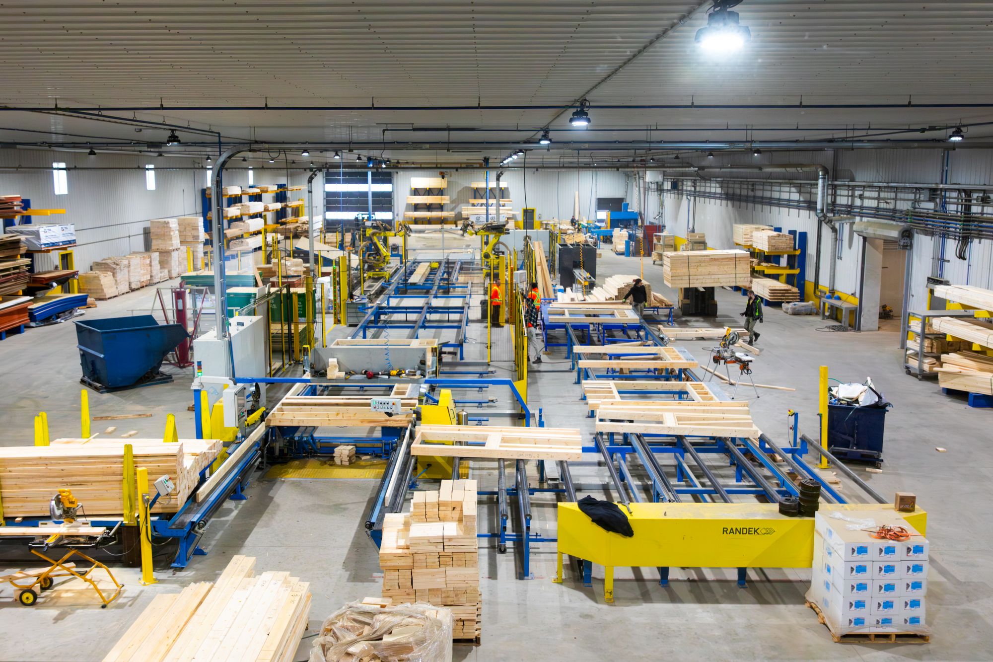 Overview of the production floor with framing lines and lumber storage.